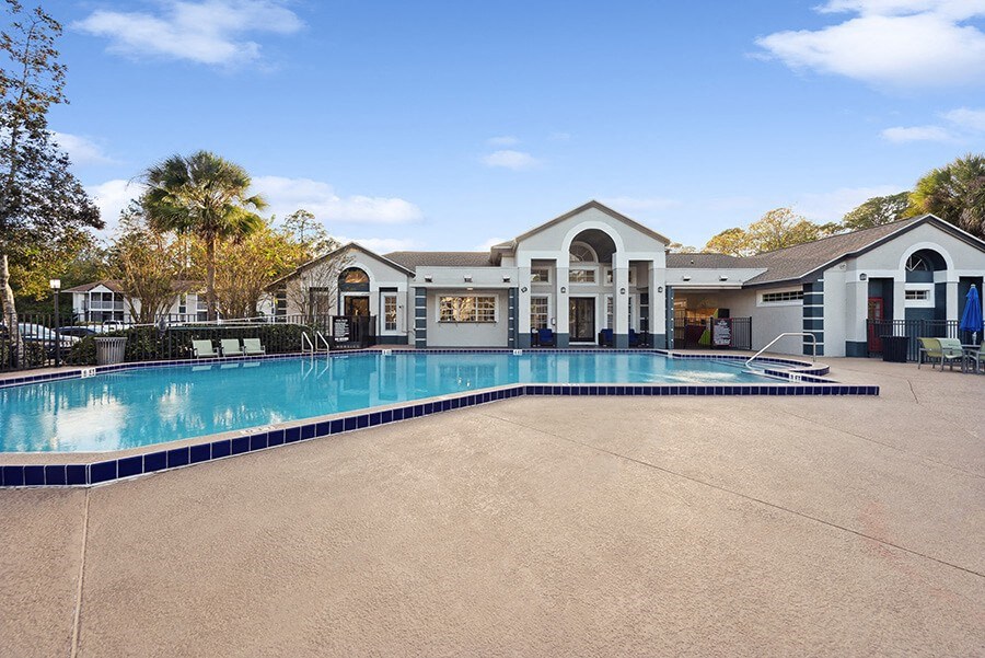 Community Swimming Pool with Pool Furniture at Vue at Baymeadows Apartments in Jacksonville, FL.