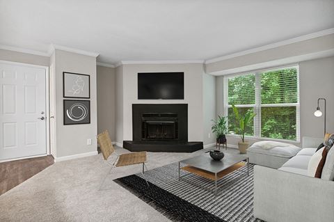 Model Living Room with Fireplace and Carpet at Arbor Village Apartments in Charlotte, NC.
