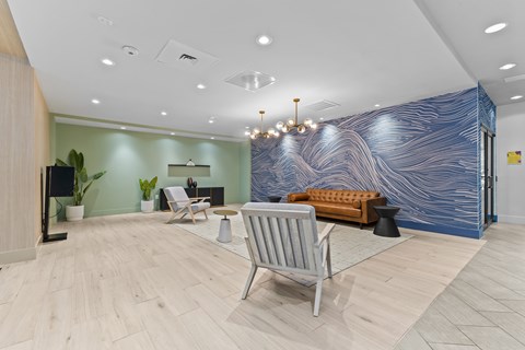A blue and white marbled wall in a room with a chair and a table.