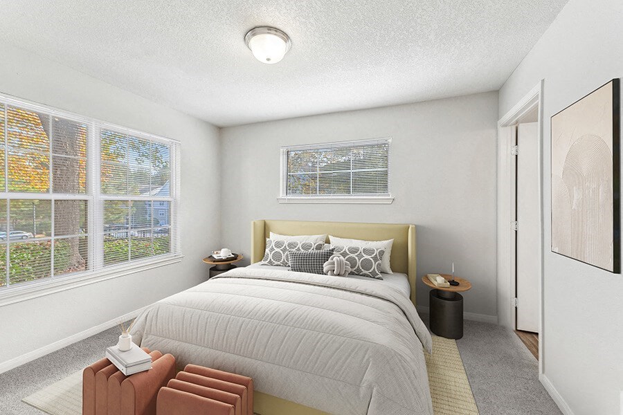 Model Bedroom with Carpet and Window View at Lake Cameron Apartments located in Apex, NC.