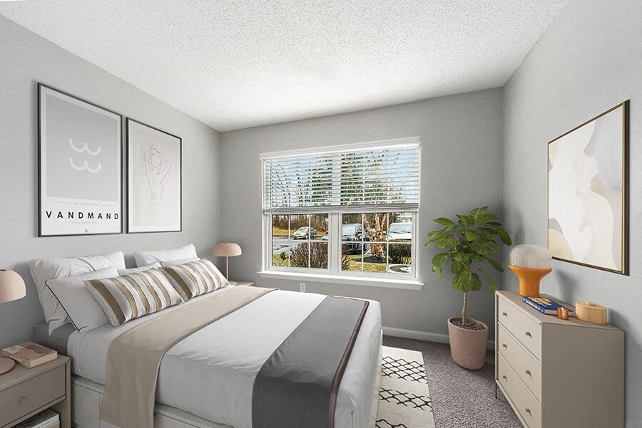 Model Bedroom with Carpet and Window View at Commons at Haynes Farm Apartments in Shrewsbury, MA.