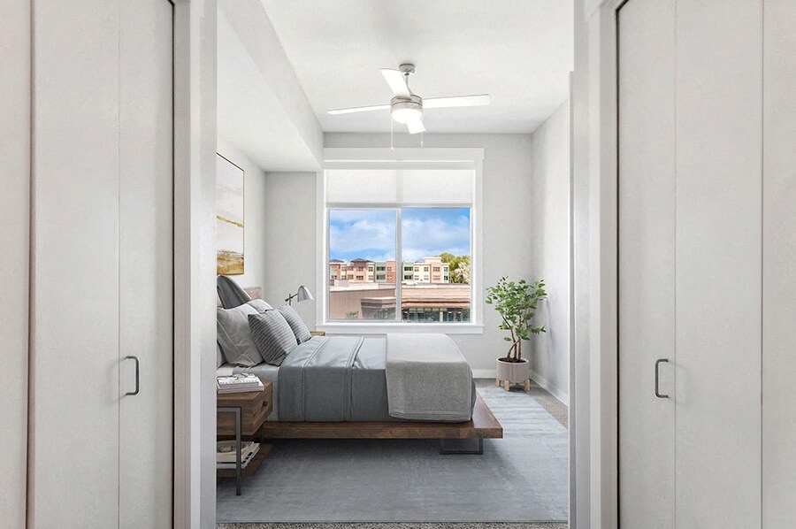 Model Bedroom with Carpet and Window View at Seven Skies Apartments located in Sandy, UT.
