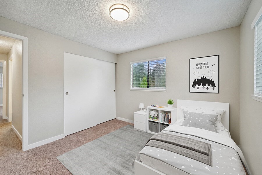 Model Bedroom with Carpet and Window View at Grammercy Apartments located in Renton, WA.