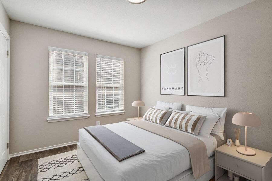 a bedroom with a bed and three windows