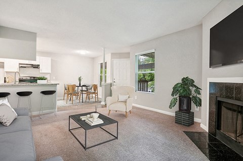 Model Living Room with Carpet, Fireplace and View of Kitchen at Park 2300 Apartments in Charlotte, NC.