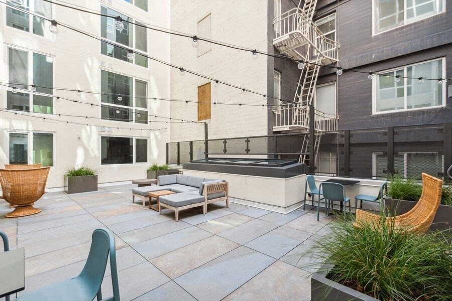 Outdoor lounge space with furniture at TL Residences