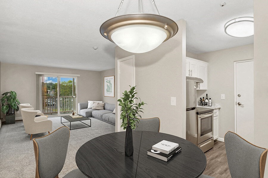 Model dining area with a table and chairs at Stone Ends apartments in Stoughton, MA