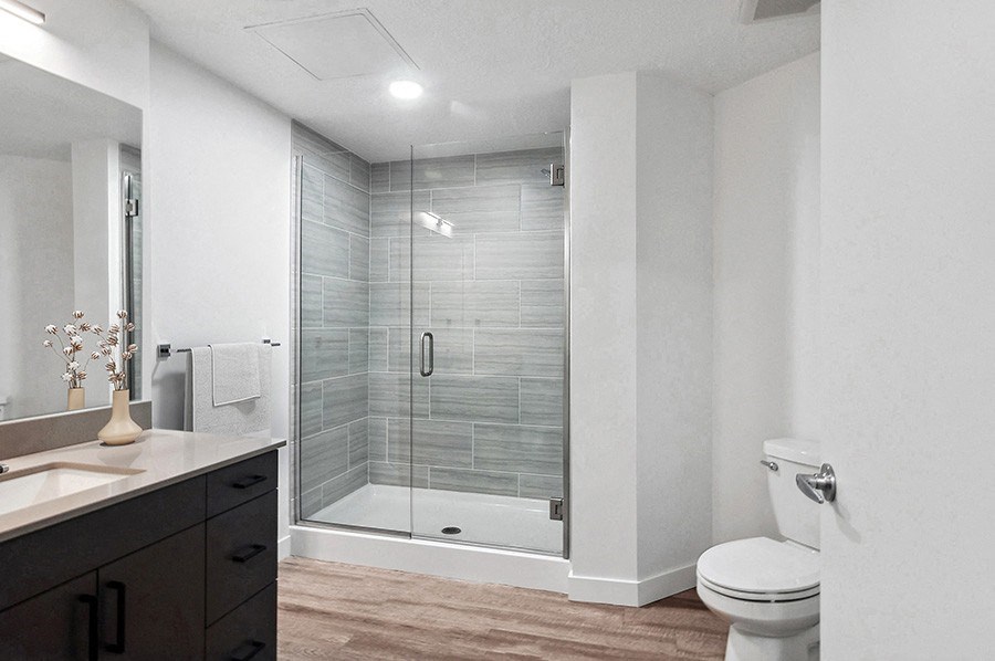 Model bathroom with large walk-in shower  at Post House North located in Post District Residences in downtown Salt Lake City, Utah