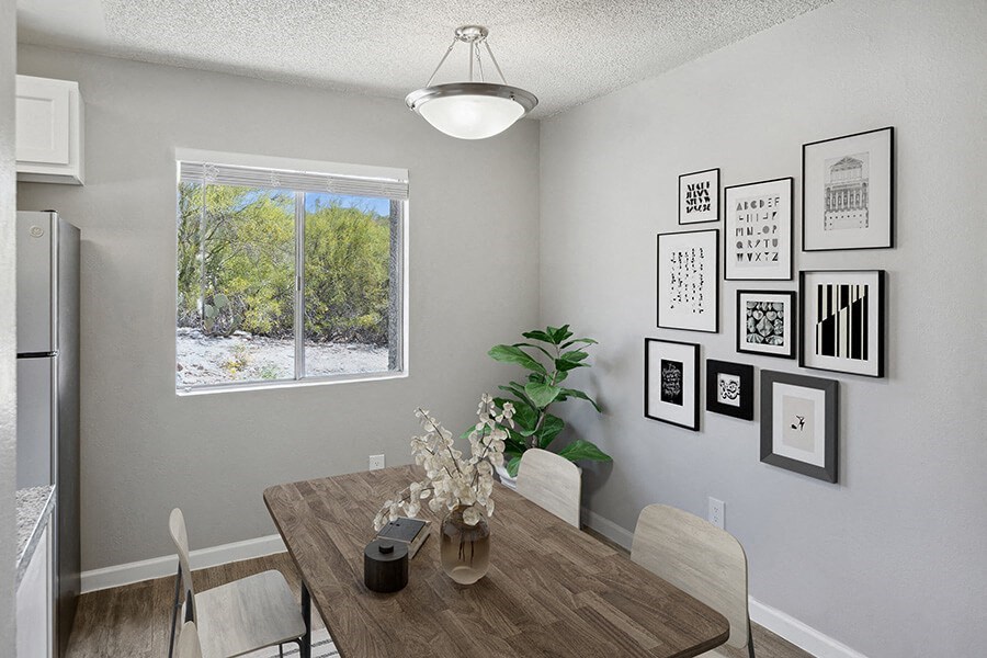 Model Dining Room with Wood-Style Flooring and Window View at Hilands Apartments in Tucson, AZ.