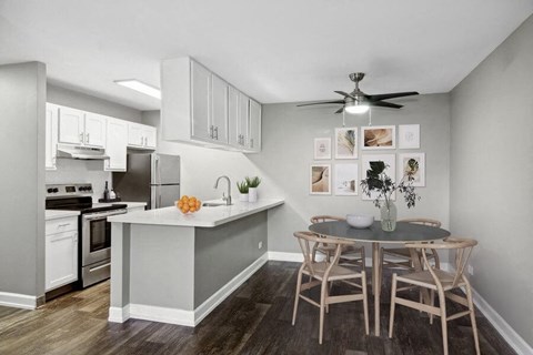 a kitchen and dining room with a table and chairs
