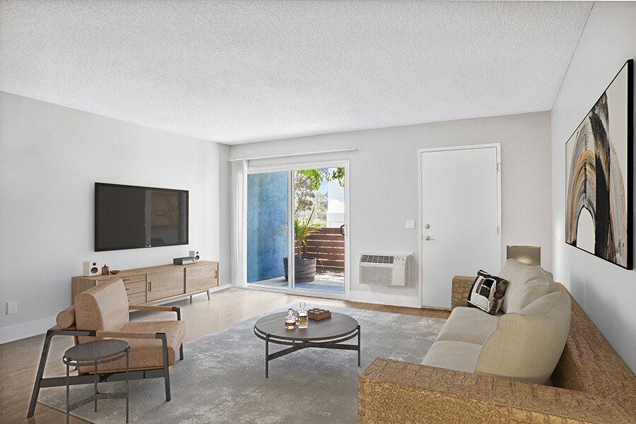 Model Living Room with Wood-Style Flooring and Patio Accessibility at Cove La Mesa Apartments located in La Mesa, CA.