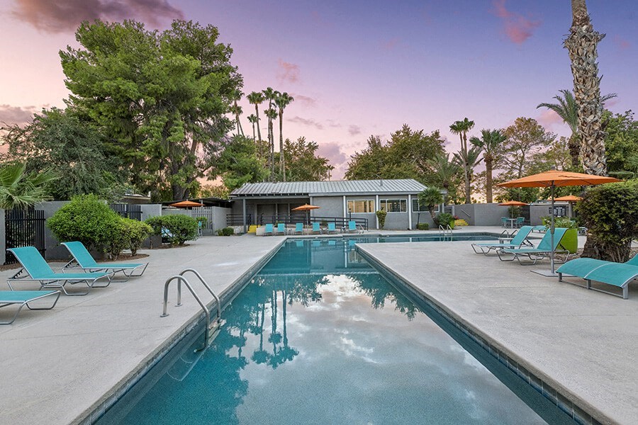 Community Swimming Pool with Pool Furniture at Lakeside Casitas Apartments located in Tucson, AZ.