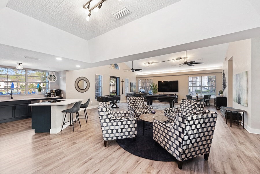 Community Clubhouse with Lounge Furniture and Kitchenette Area at Vue at Baymeadows Apartments in Jacksonville, FL.