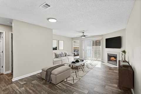 Model Living Room with Wood-Style Flooring, Fireplace and Patio Accessibility at Element 41 Apartments located in Marietta, GA.