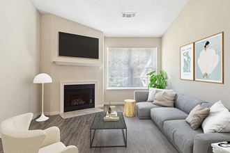 Model Living Room with Wood-Style Flooring and Fireplace at The Commons at Haynes Farm Apartments in Boston, MA.