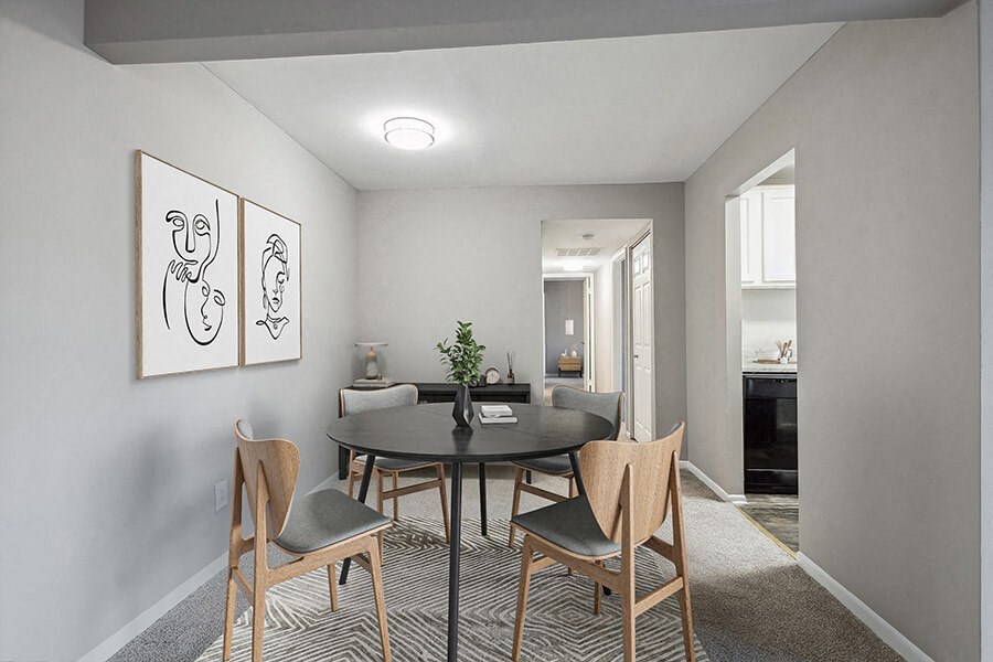 Model Dining Room with Carpet and View of Kitchen at Spring Parc Apartments in Silver Spring, MD.