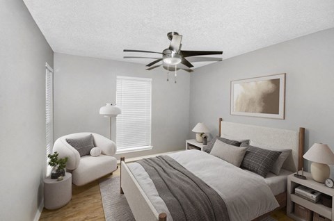 Model bedroom with a bed and a ceiling fan