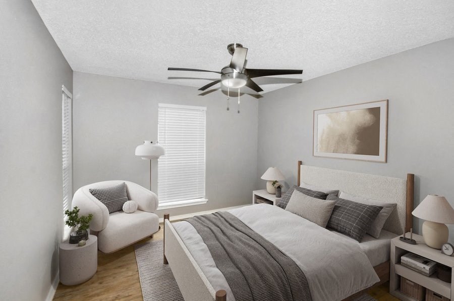 Model bedroom with a bed and a ceiling fan