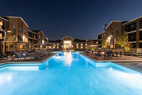 Community Swimming Pool with Pool Furniture at Alta 3Eighty Apartments located in Aubrey, TX.