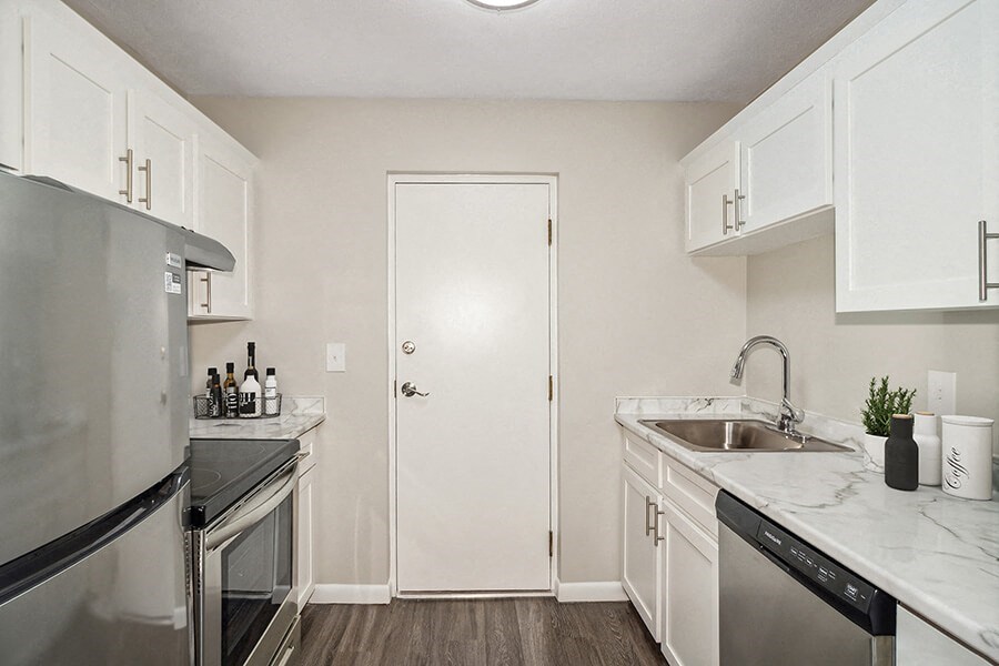 Mode kitchen with white cabinets and stainless steel appliances  at Stone Ends apartments in Stoughton, MA