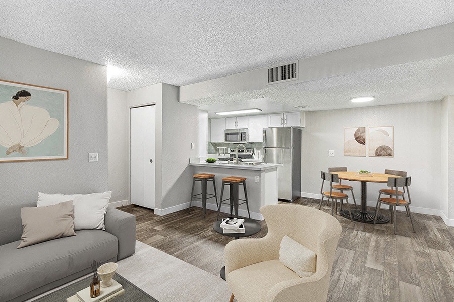 Model Living Room and Kitchen/Dining Room Area with Wood-Style Flooring at Meadow Ridge Apartments in Las Vegas, NV.