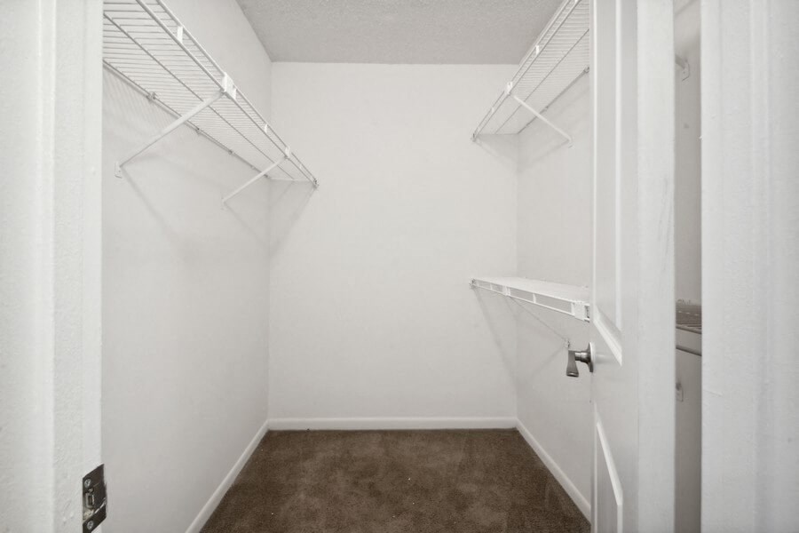 Model primary bedroom walk-in closet