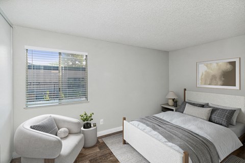 a bedroom with a bed and a chair and a window