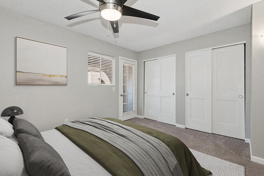 Model Bedroom with Carpet and Double Closets at Stillwater Apartments in Glendale, AZ.
