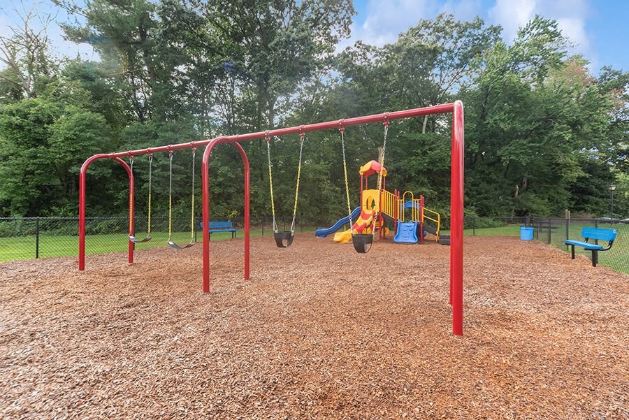Community Playground with Slide and Swing Set at Meadows at Marlborough Apartments in Boston, MA.