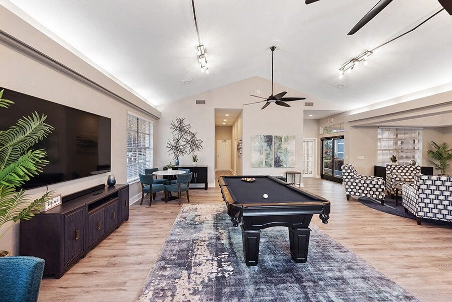 Community Clubhouse with Lounge Furniture and Pool Table Area at Vue at Baymeadows Apartments in Jacksonville, FL.
