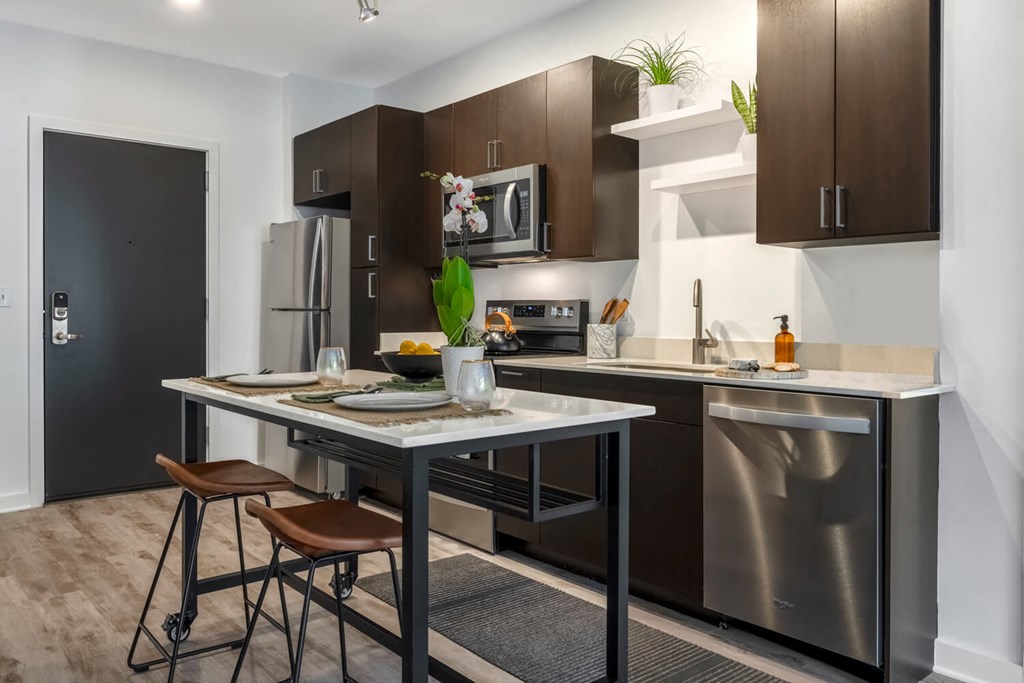 Model kitchen with an island and stainless steel appliances