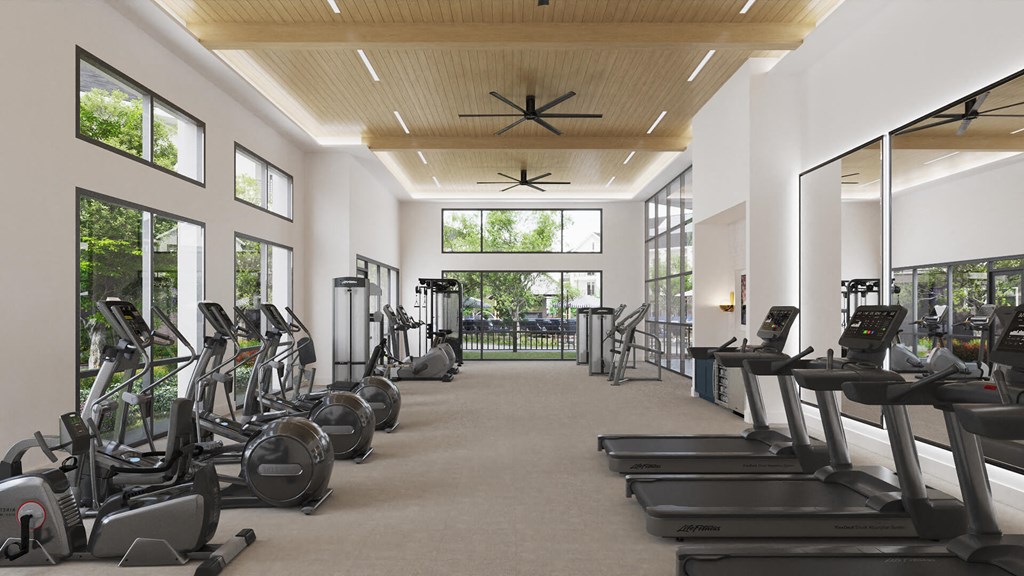 Fitness center loaded with cardio and weightlifting equipment at The Howard Apartments in Manor, Texas