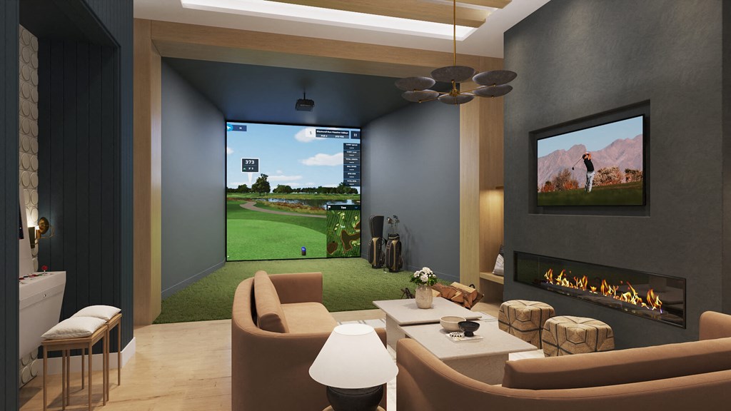 Golf simulator and fireplace lounge at The Howard Apartments in Manor, Texas