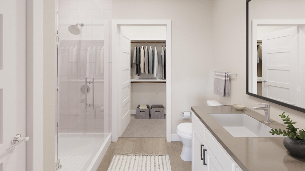 Model bathroom with light vanity at The Howard Apartments in Manor, Texas