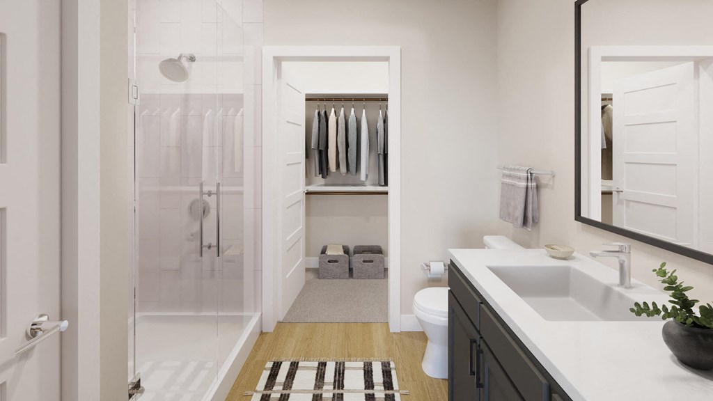 Model bathroom with dark vanity at The Howard Apartments in Manor, Texas