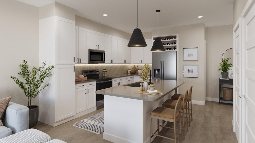 Model kitchen with light cabinetry at The Howard Apartments in Manor, Texas