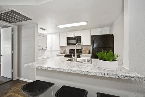 a kitchen with a counter top and a sink