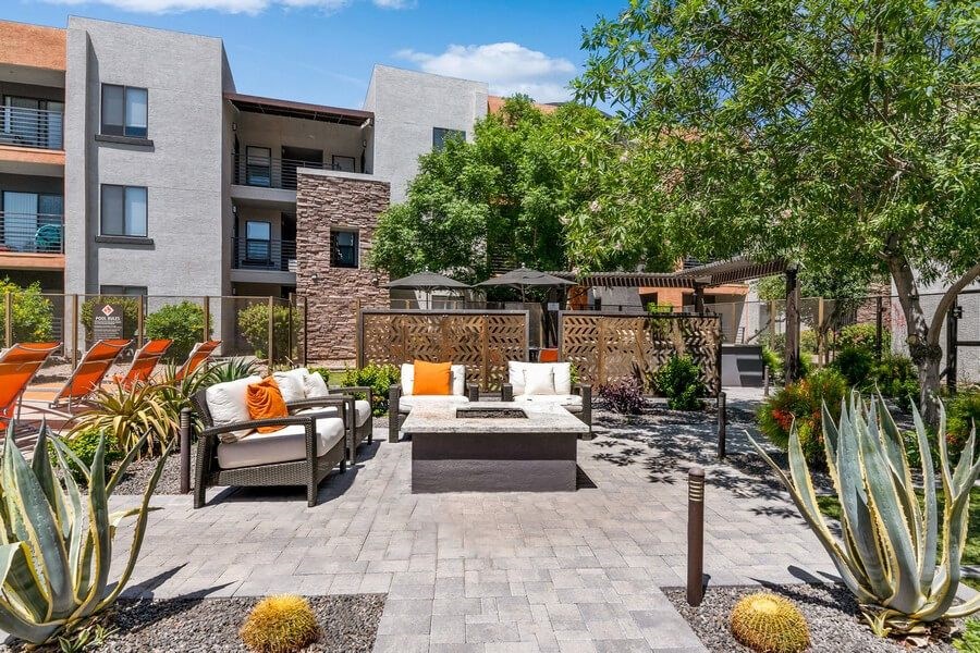 Community Fire Pit Area with Patio Furniture at Harmony at Surprise Apartments in Surprise, AZ.