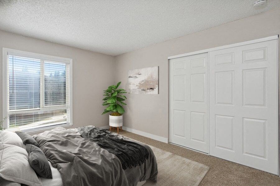 Model bedroom with a bed and a window