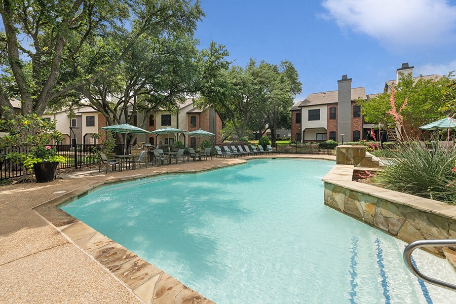 Community Swimming Pool with Pool Furniture at Dallas North Park Apartments in Dallas, TX.