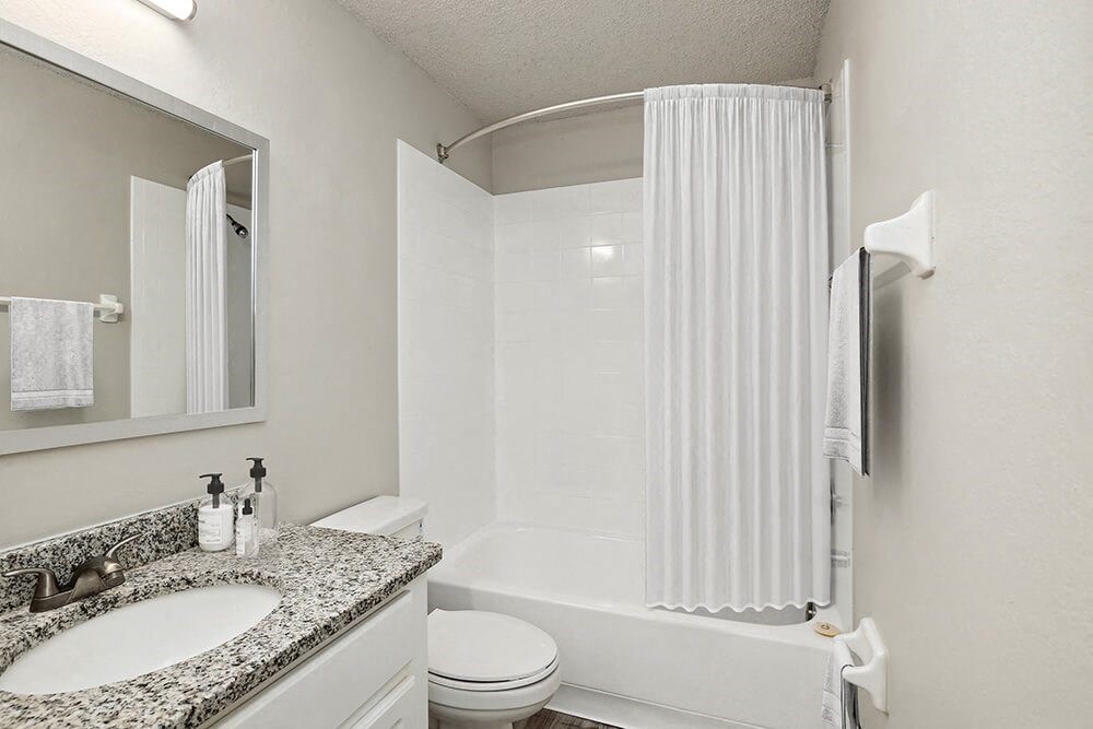 Model bathroom with a sink toilet and bathtub
