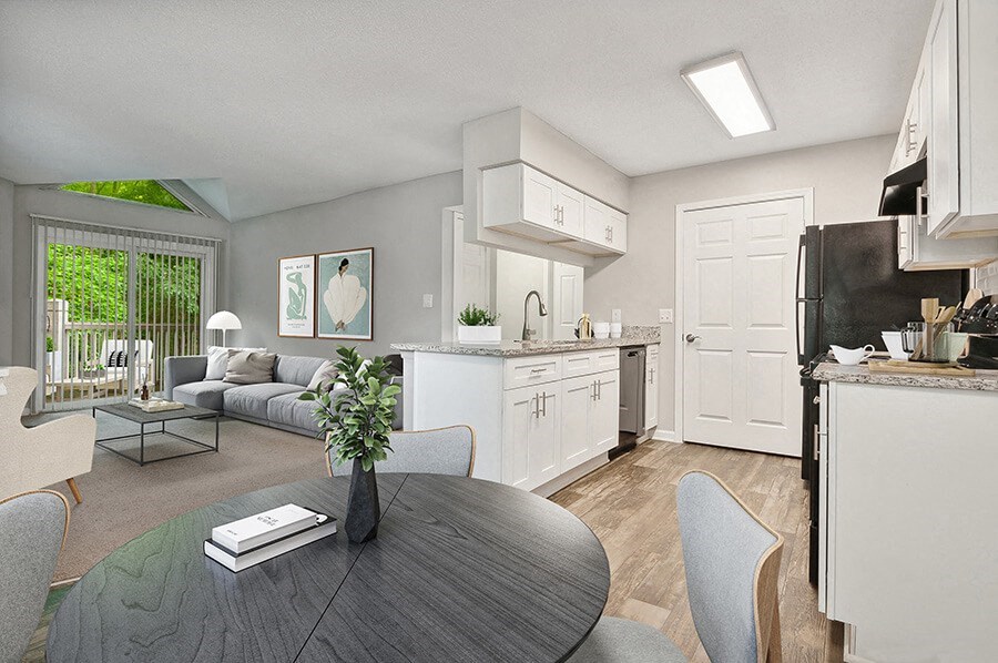 Model Kitchen with Wood-Style Flooring, White Cabinets and View of Living Room at Park 2300 Apartments in Charlotte, NC.