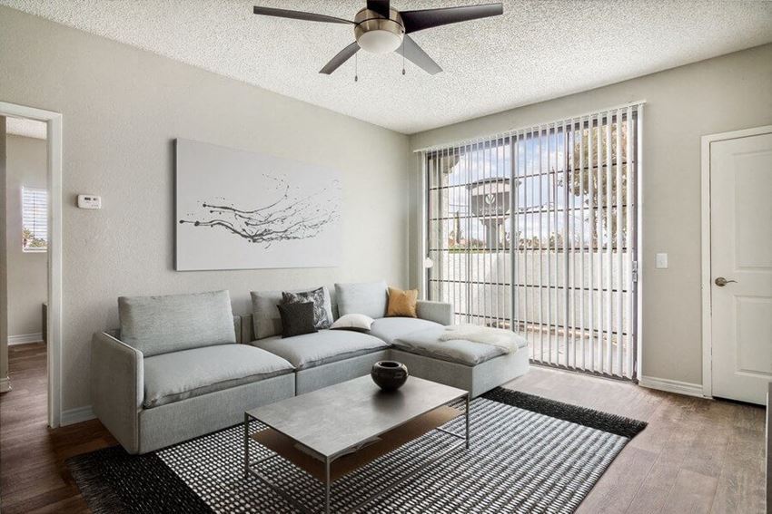 a living room with a couch coffee table and a ceiling fan - Photo Gallery