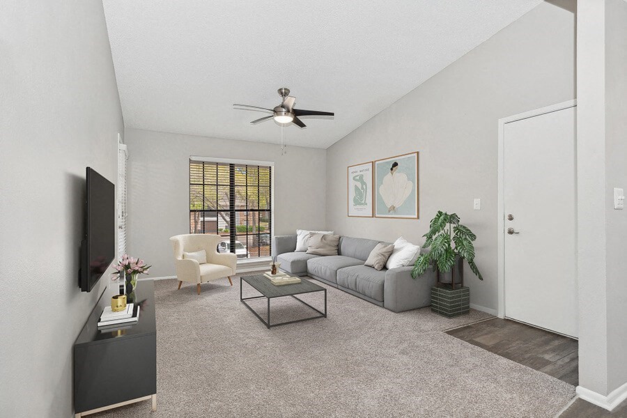 Model Living Room with Carpet and Window View at Grand Pavilion Apartments in Tampa, FL.