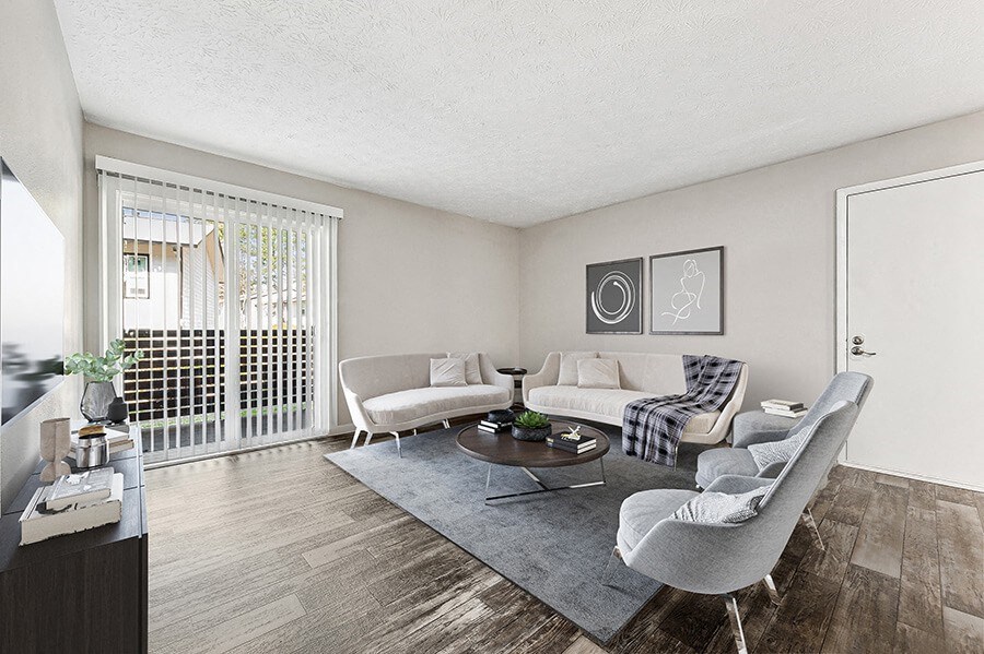 Model Living Room with Wood-Style Flooring and Patio Accessibility at Paramont Apartments in Duluth, GA.