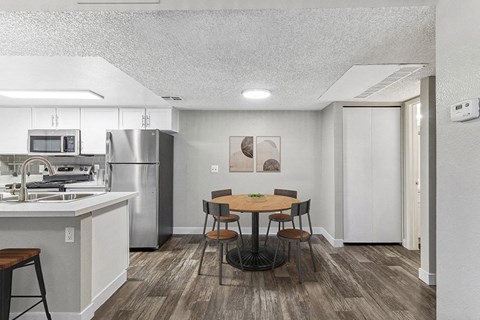 a kitchen and dining room with a table and chairs