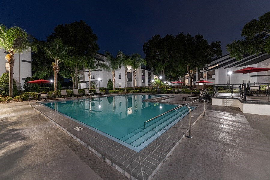 Community Swimming Pool with Pool Furniture at Rosehill Preserve Apartments located in Orlando, FL.