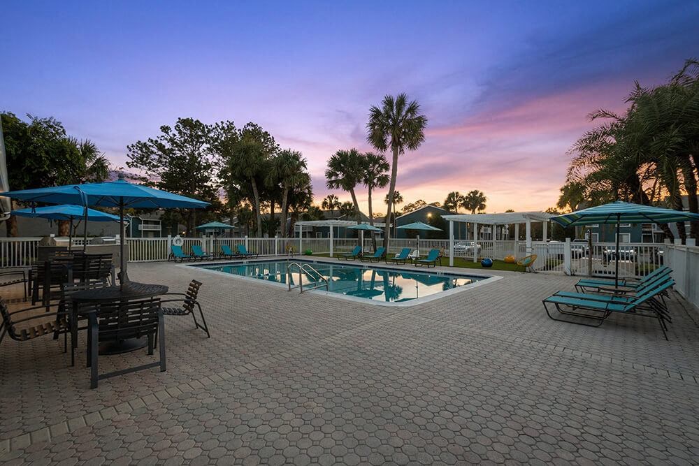 Community Swimming Pool with Pool Furniture at Park at 7200 Apartments in Jacksonville, FL.