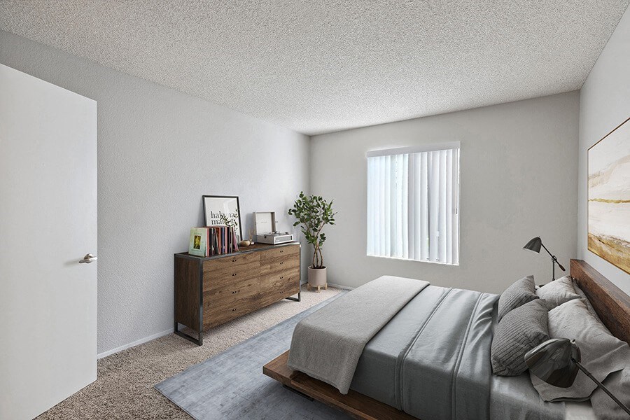 Model Bedroom with Carpet and Window View at Bridges on Sunset Apartments in Suisun City, CA.