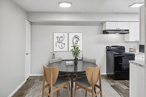 a kitchen and dining room with a table and chairs